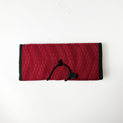 Red snakeskin travel pouch with a sleek and functional design, perfect for keeping your items safe while traveling.