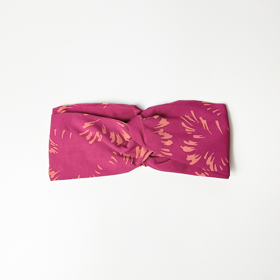 a whitebox headband in the pattern fuchsia paw against a white background