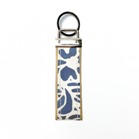 A keyfob with batik fabric at the centre and leather, front view