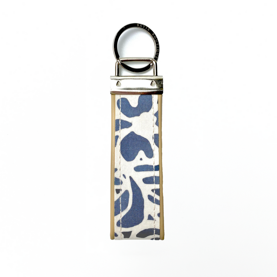 A keyfob with batik fabric at the centre and leather, front view