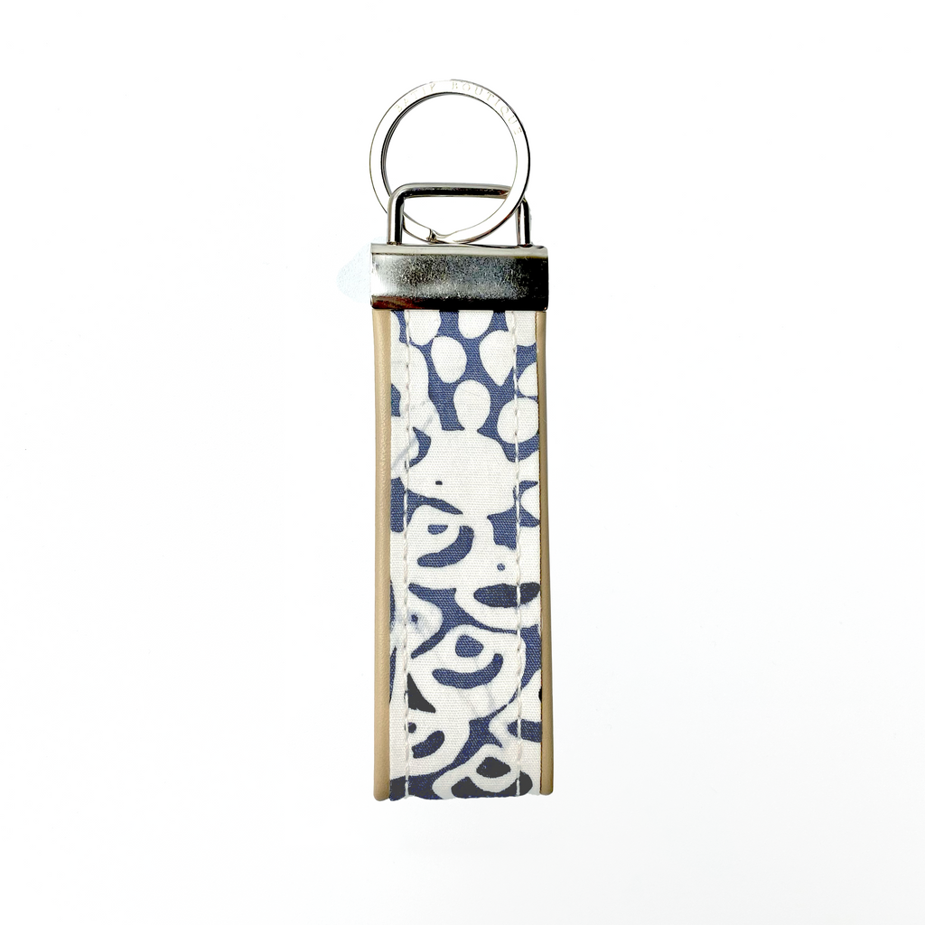 A keyfob with batik fabric at the centre and leather, back view