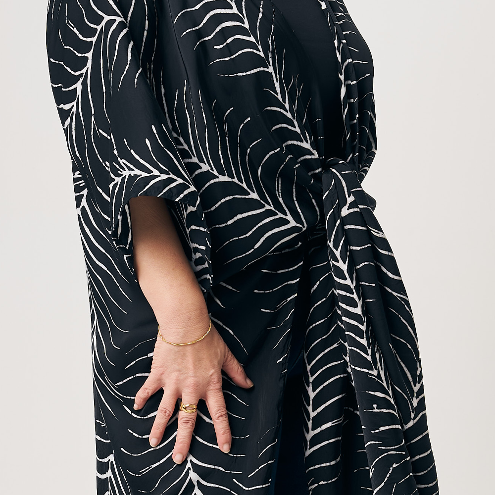 a closeup of batik kimono in the pattern black fern