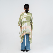 Back view of a woman wearing Batik Boutique's Kimono in Moss Bukit print, showcasing soft green and beige batik patterns inspired by Malaysian hills