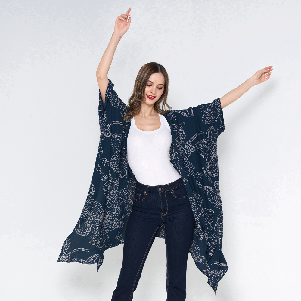 a woman posing in a batik kimono against a white background navy orchid