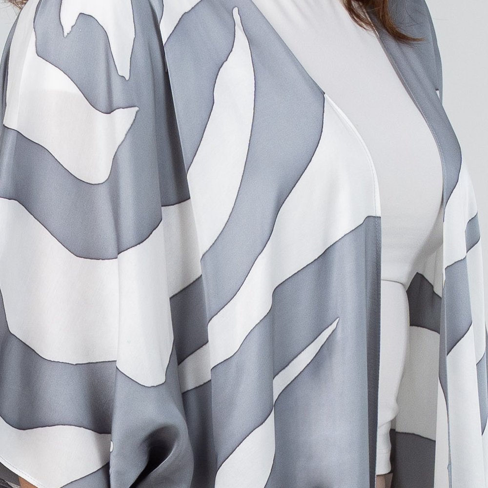 Close-up of Silver Rose batik kimono fabric, showcasing delicate silver and white floral design on premium silk cotton