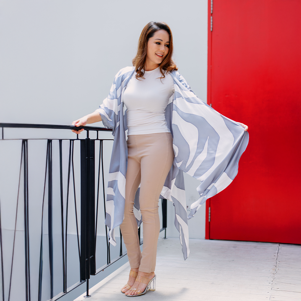 Woman wearing Silver Rose kimono outdoors, styled casually, highlighting flowy cut and soft silver batik print