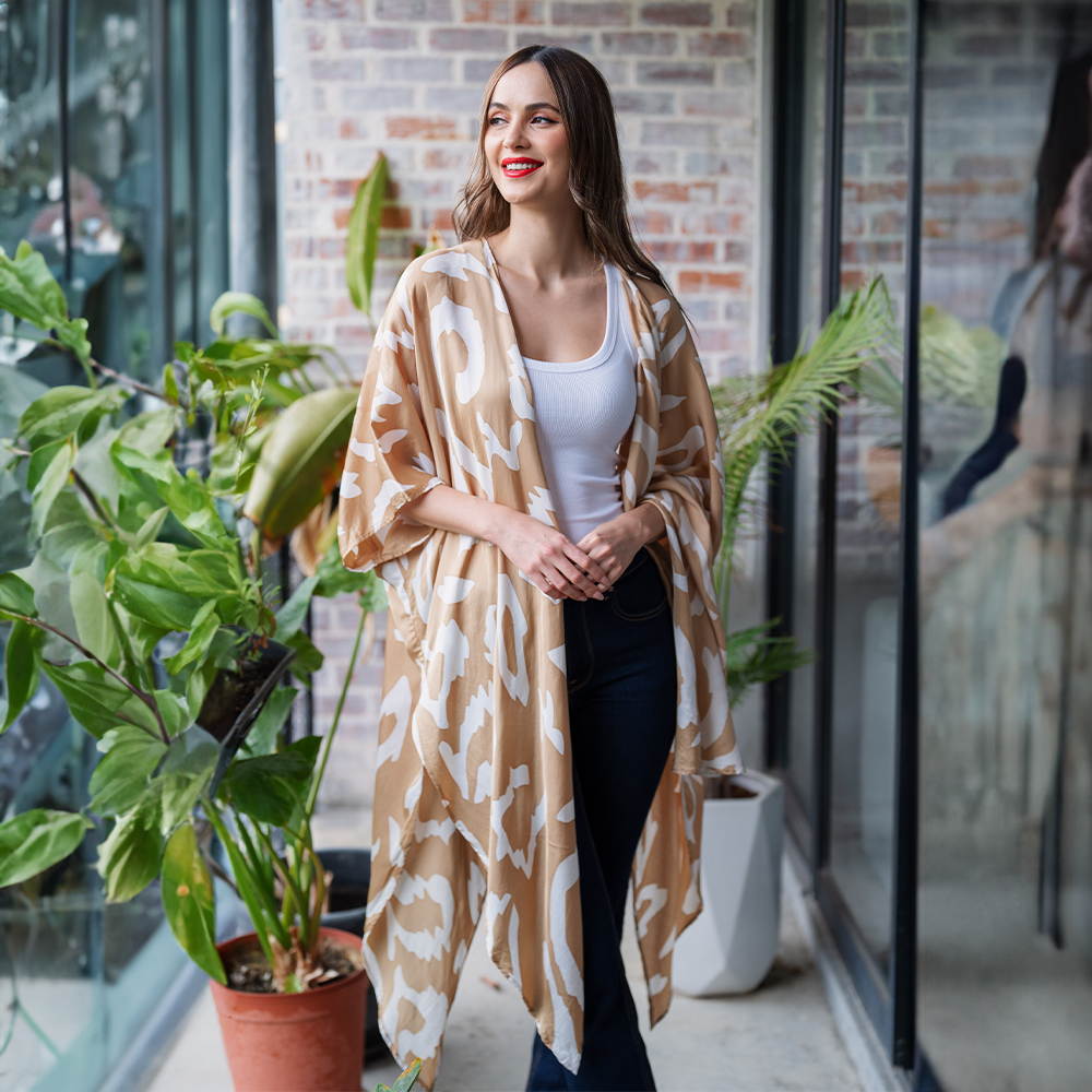 a woman posing in a batik kimono in an outdoor setting in the pattern tan rimba