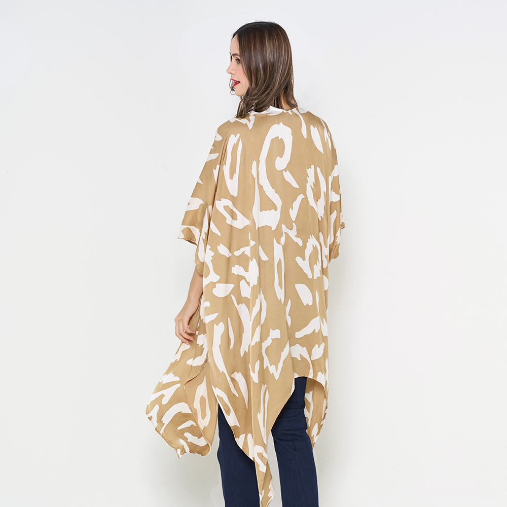 a woman posing in a batik kimono against a white background showcasing the batik in the pattern tan rimba