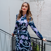 a woman wearing a long shirt dress made with batik fabric in the pattern sapphire fleur