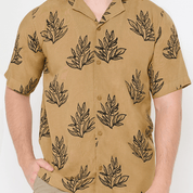a closeup of batik cuban shirt in the pattern tan olive leaf