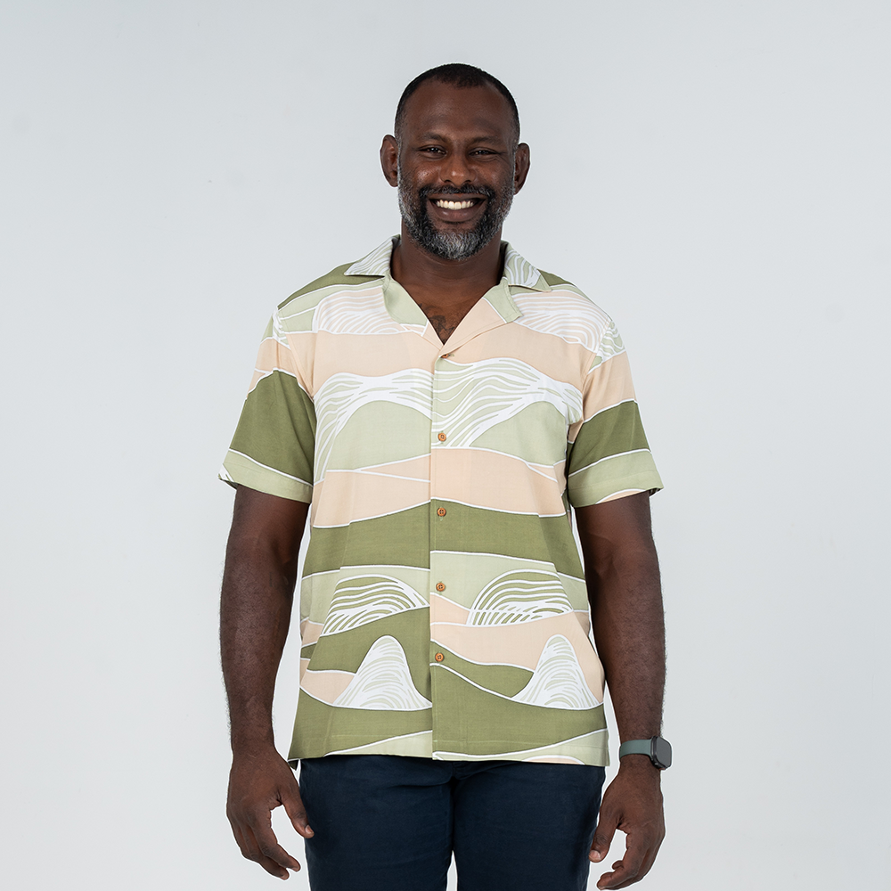 Front view of a model wearing Batik Boutique's Moss Bukit men's Cuban shirt, highlighting its relaxed fit and contemporary batik design