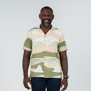 Front view of a model wearing Batik Boutique's Moss Bukit men's Cuban shirt, highlighting its relaxed fit and contemporary batik design