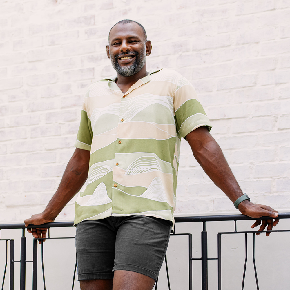 Model styling the Moss Bukit batik Cuban shirt outdoors, blending Malaysian heritage with a modern, casual look for men