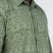 Closeup of Olive Anyam batik motif and wooden buttons on shirt
