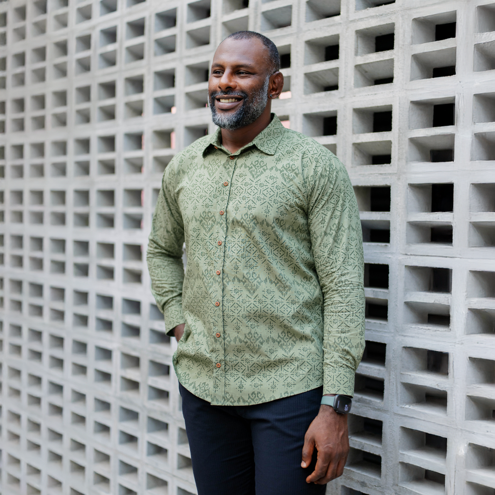 Man wearing Olive Anyam batik shirt in outdoor lifestyle setting