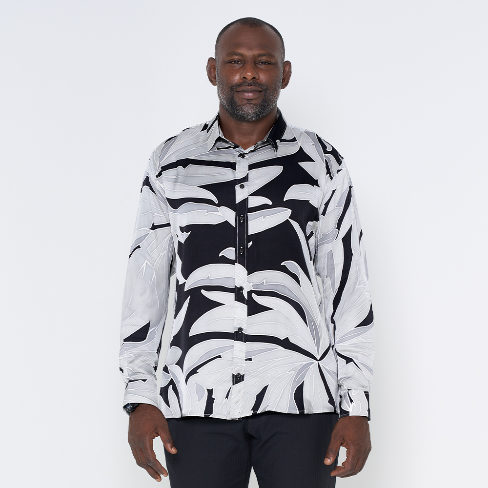 a man wearing a batik shirt in the pattern starry palma