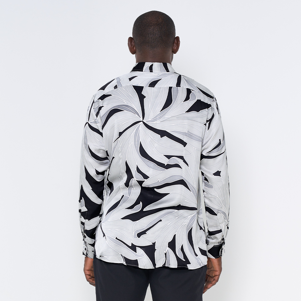 a man showcasing the pattern starry palma batik shirt in long sleeved cutting