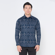 a man posing against a white background in a batik shirt in the pattern navy anyam