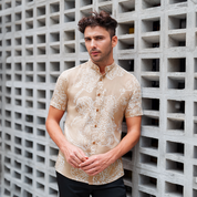 a man wearing a batik shirt in the pattern tan orchid with mandarin collar