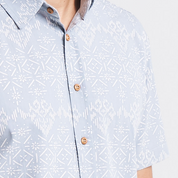 A close-up shot highlighting the intricate batik pattern, inspired by the traditional weaving technique, and the fine craftsmanship of the fabric