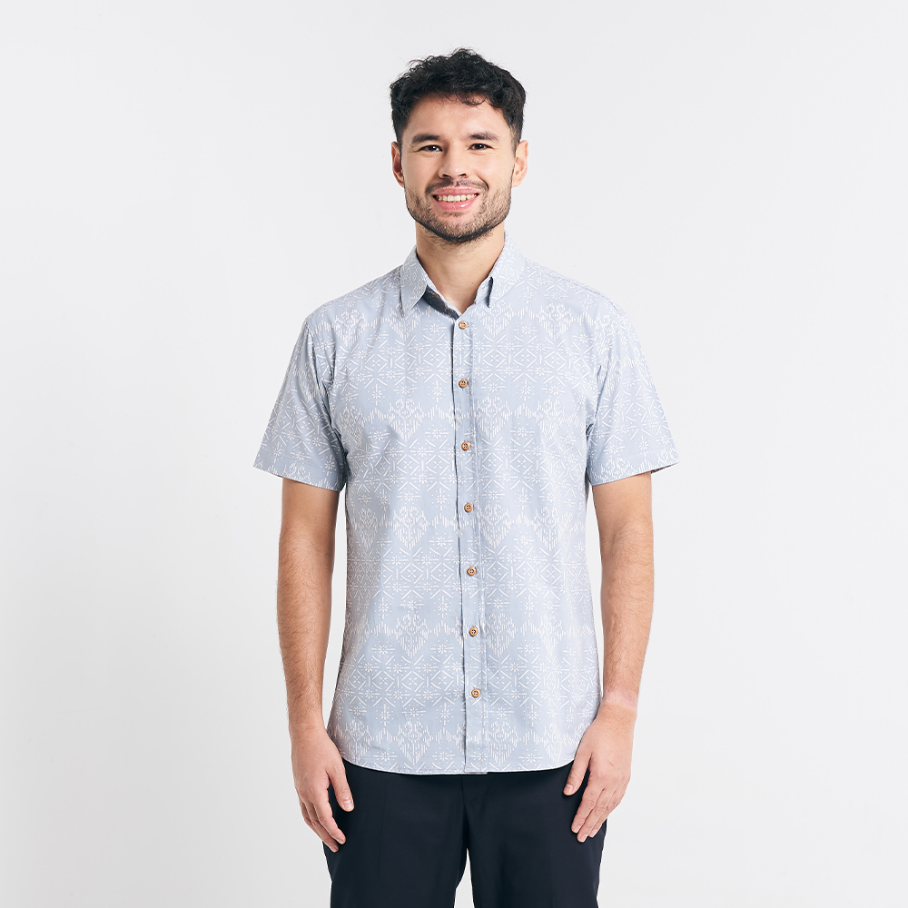  A full-body studio shot showcasing the modern fit of the Grey Anyam shirt, featuring darts at the back for a structured yet relaxed look