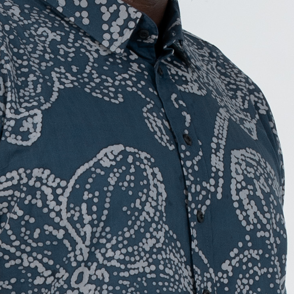 Close-up of navy batik shirt for men with fine wax dot detailing of orchid pattern and breathable cotton texture
