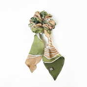 Moss Bukit batik scrunchie with ribbon tail on white background.