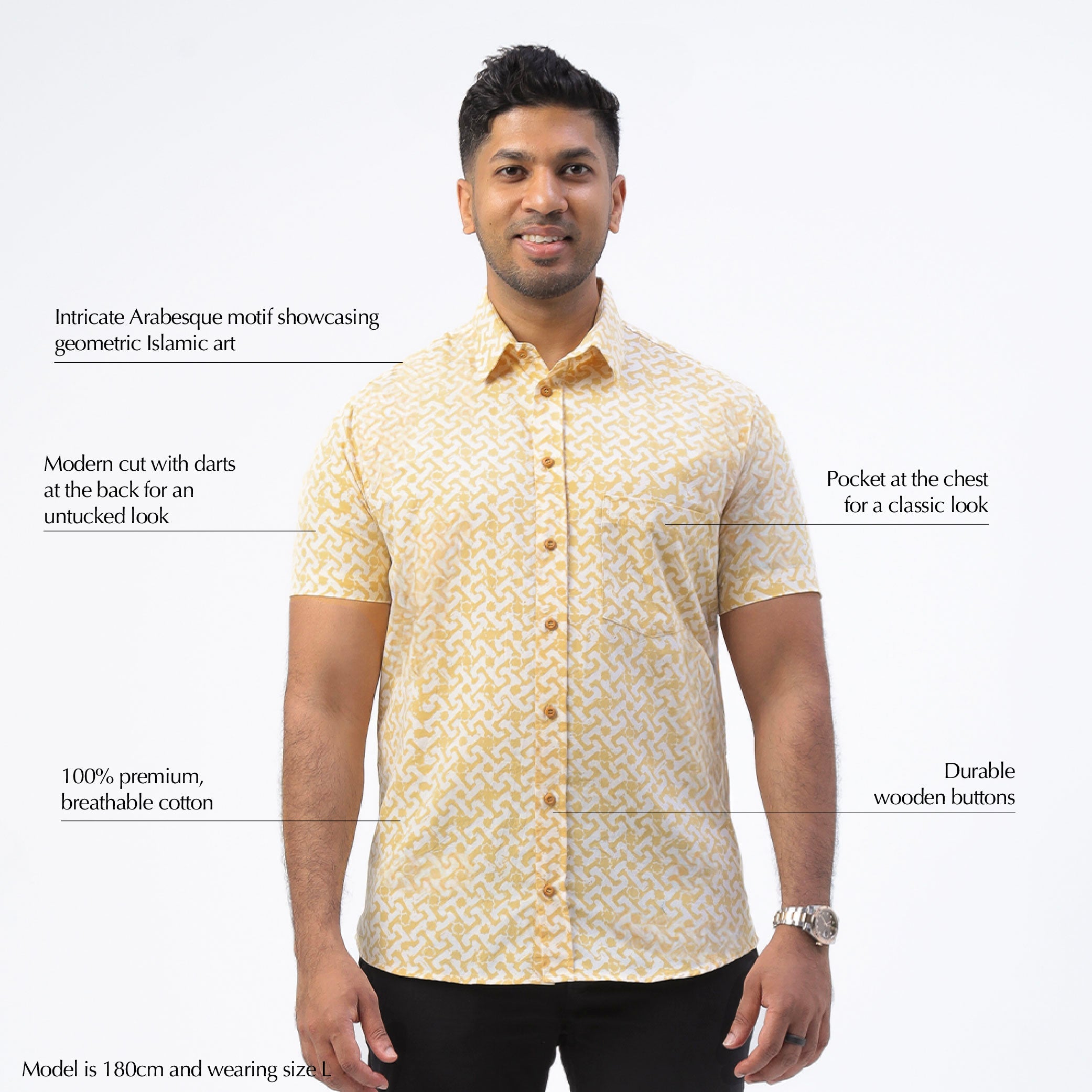 a man wearing a batik shirt against a white background in the pattern mustard arabesque