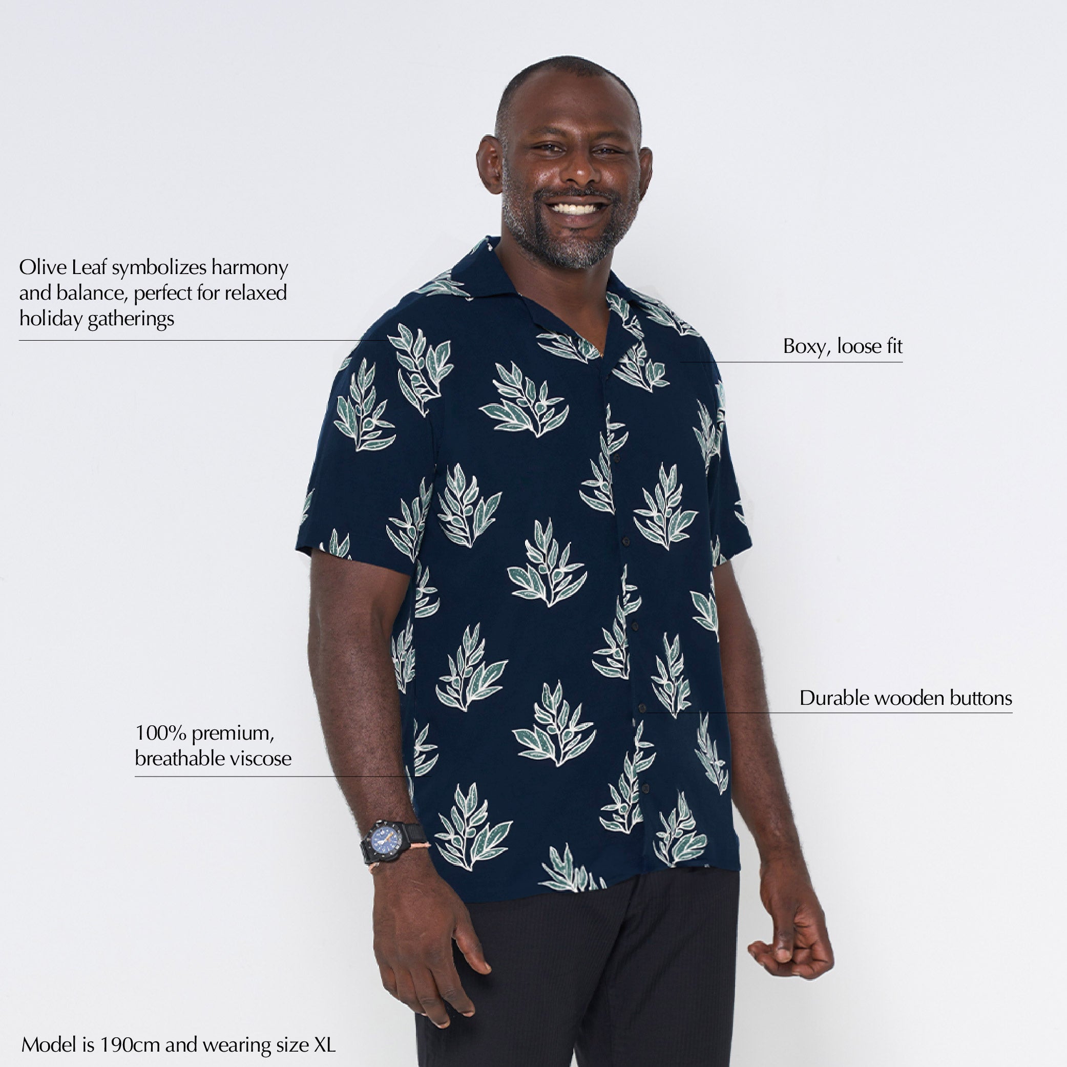 man in navy olive leaf against a white background batik shirt