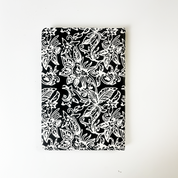 Handcrafted batik notebook with black background and white floral pattern — Black Floret design by Batik Boutique.
