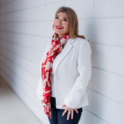 a woman in a lifestyle photo in a batik scarf in the pattern fleur red scarf