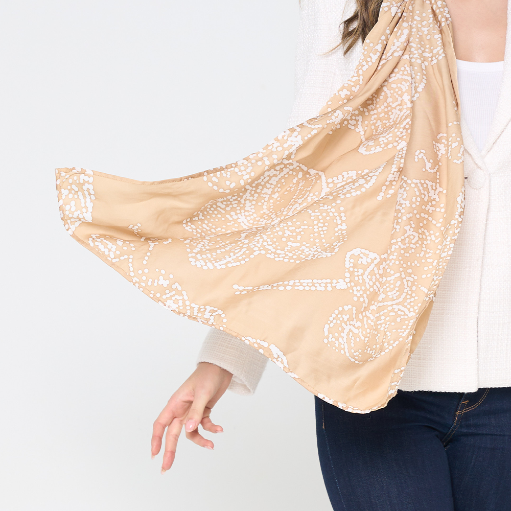 a closuep of batik scarf in the pattern tan orchid