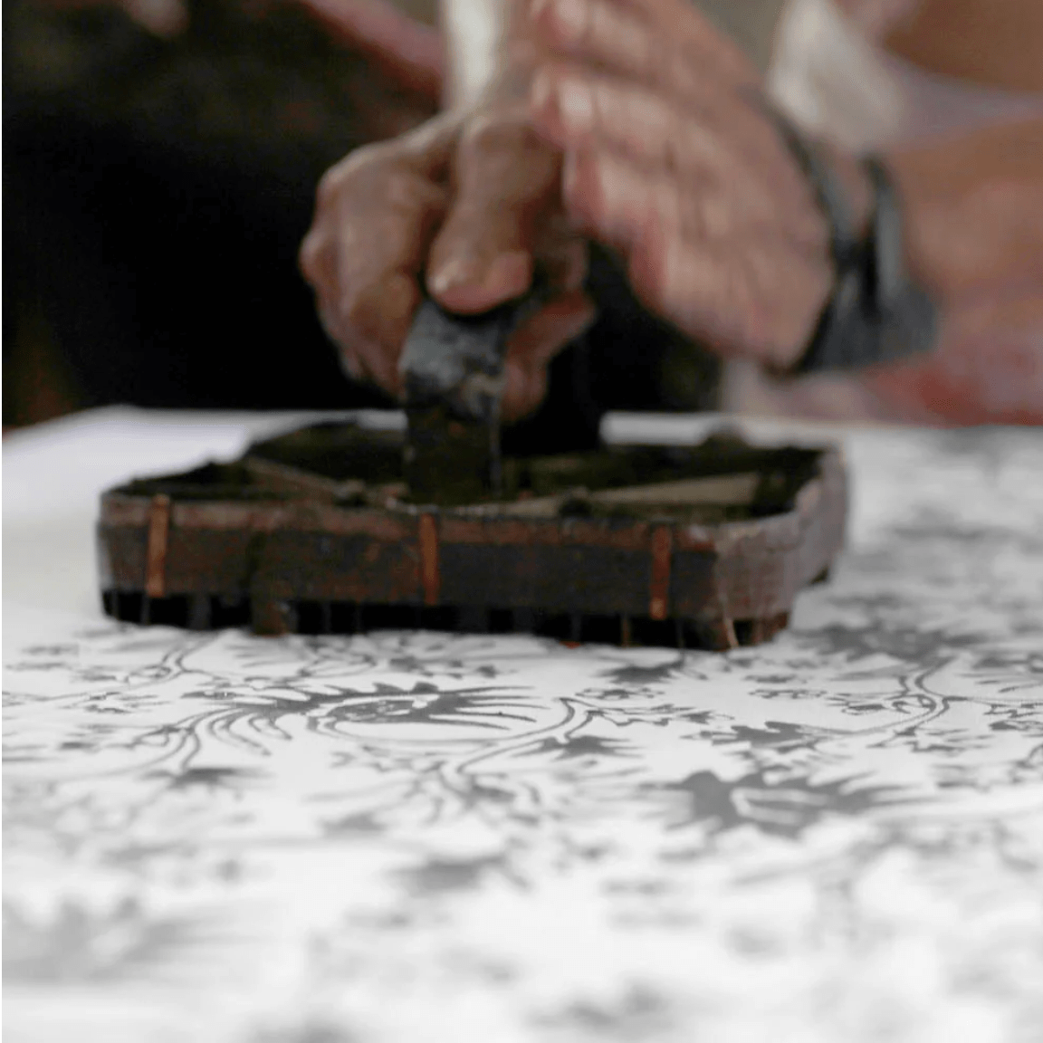 Sage green batik drawstring pouch with white floral motif, handmade by Batik Boutique artisans using traditional batik techniques.