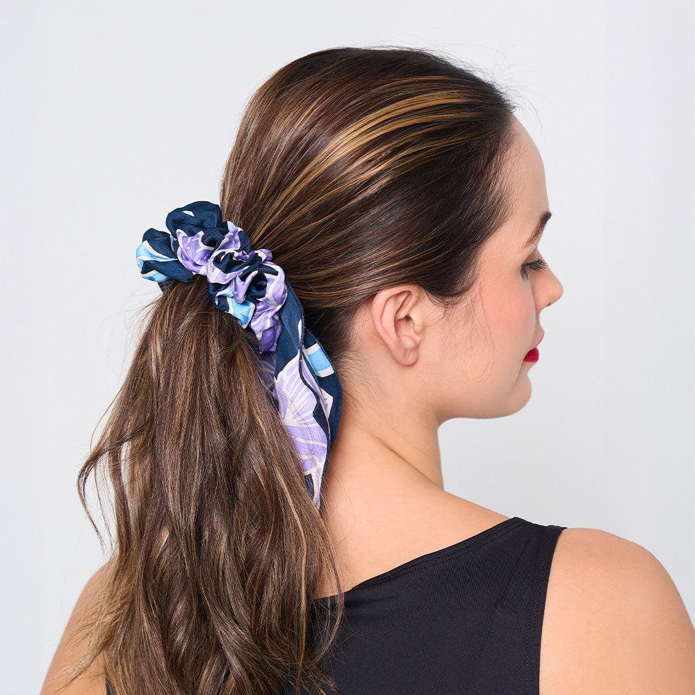 a whitebox photo of a model wearing a batik scrunchies in the pattern sapphire fleur against a white background