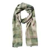 Presentation of a long batik scarf in olive cotton silk.