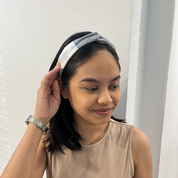 Model wearing Batik Boutique Silver Rose batik headband in soft grey and white tones