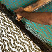 Artisan photo of the garnet snake fabric being made 