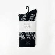 a batik inspired black snakeskin against a white background socks 