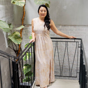 Women posing wearing a tan orchid maxi dress 