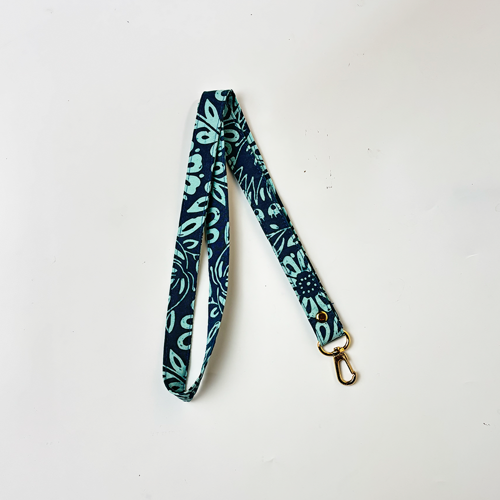 Batik Lanyard  Teal Ukir in a white box black ground and shown folded 