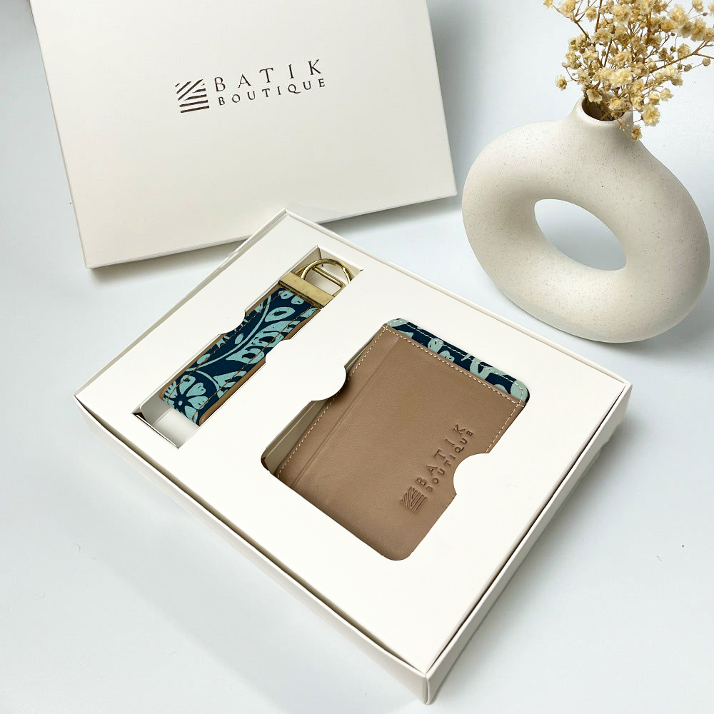 a lifestyle photo of travel set in the pattern teal ukir against a white background in a box 