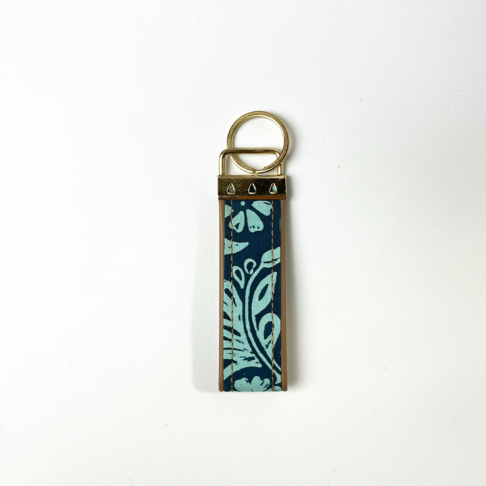 the back of a key fob in the pattern teal ukir 