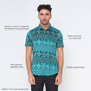 a man in a batik shirt in the pattern turquoise anyam against a white background