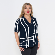 a woman posing in front of a white background in a batik cuban shirt for women in the pattern navy brush