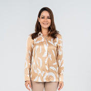 Front view of a model in a Tan Rimba long-sleeved shirt made from silk cotton, featuring a neutral beige and white batik motif inspired by the Malaysian jungle