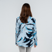 Back view of women's long-sleeved batik shirt in Moonlight Palma print, featuring hand-drawn palm leaves in light and dark blue tones