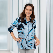 Model wearing Moonlight Palma batik shirt in a modern indoor setting, styled for everyday elegance