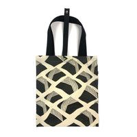 A batik totebag or even a shopping bag with pattern inspired from Nasi Lemak in black color and put on a white background. This photo show the front side of the bag