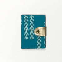 a photo of a passport cover made of batik in the pattern mint arrow