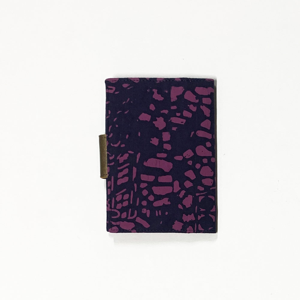 the back view of a passport cover made of batik in the pattern purple bintik